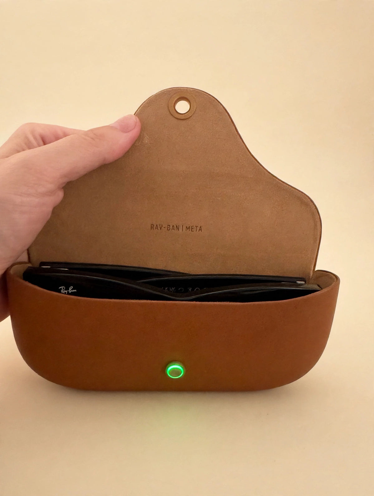 Ray-Ban Meta charging case open with green charging light